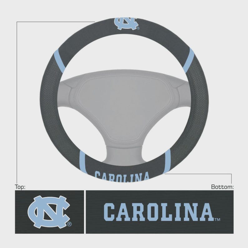May include: A black steering wheel cover with light blue accents and the word "CAROLINA" in light blue. The cover features the University of North Carolina logo. The cover is designed to fit a standard steering wheel.