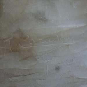 May include: Close-up of a white marble sculpture with the inscription "T. Cavazza" carved into the surface.