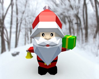 May include: A red and white origami Santa Claus holding a green gift box and a gold bell in a snowy winter scene.