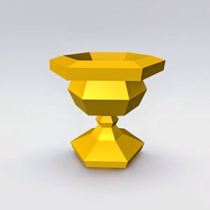 May include: A gold-colored, geometrically shaped vase with a wide base and a narrow neck.