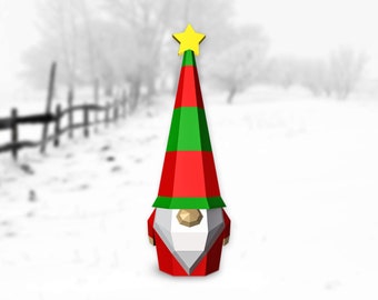 May include: A red and green Christmas gnome with a white beard and a yellow star on top of its hat. The gnome is standing in a snowy landscape.