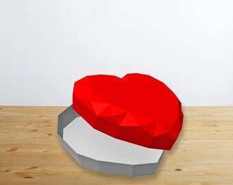 May include: A red heart-shaped box with a white interior, open and resting on a wooden surface.