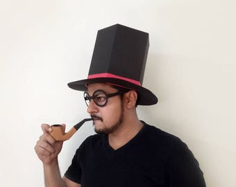 May include: A person wearing a black top hat with a pink band and round glasses, holding a brown pipe.