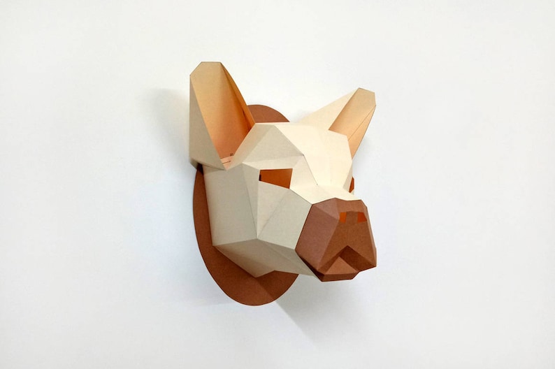 May include: A papercraft sculpture of a dog's head, with a white and brown colour scheme. The sculpture is made of folded paper and has a three-dimensional effect.