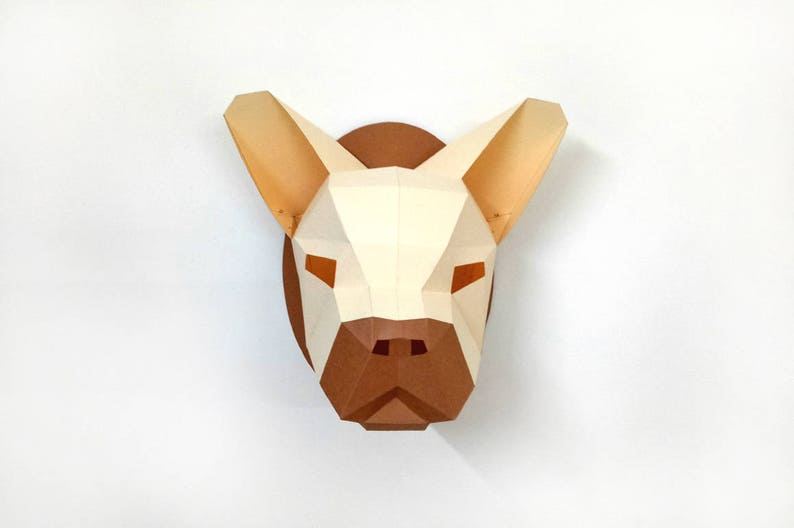 May include: A papercraft sculpture of a French bulldog head, with a white and brown colour scheme. The sculpture is made of folded paper and has a three-dimensional effect.