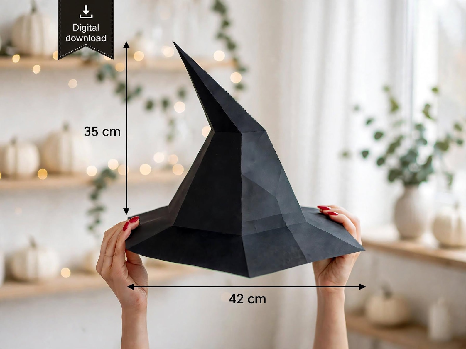 A Dramatic Low-Poly Bent Point Large black faceted paper witch hat model held in front of a table.