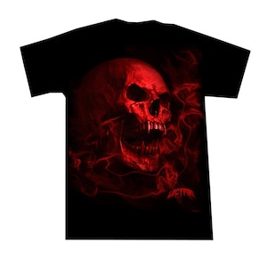May include: Black t-shirt with a red skull graphic surrounded by red flames. The skull has a menacing expression with sharp teeth and a large, open mouth.