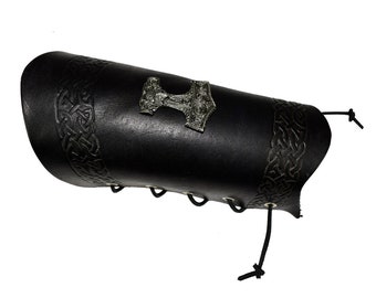 One long leather bracer with a thorshammer stud and embossed  celtic knotwork