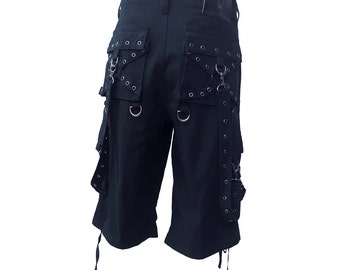 May include: Black cargo shorts with multiple straps, buckles, and grommets. The shorts have a relaxed fit and are made of a durable cotton blend.