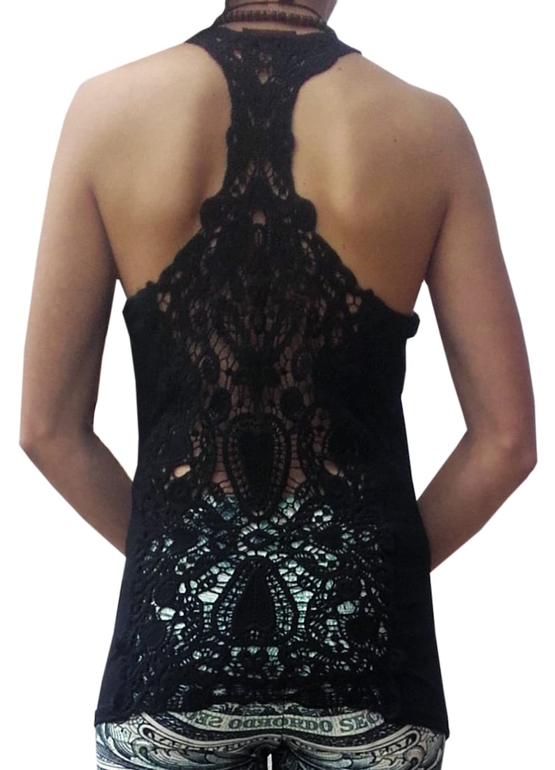 May include: Black tank top with a lace back design. The lace is intricate and covers the entire back of the top.