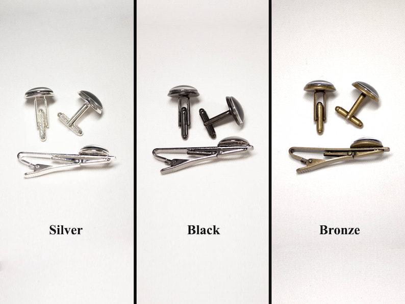 May include: Three sets of cufflinks and tie clips in silver, black, and bronze. Each set includes a pair of cufflinks and a tie clip.