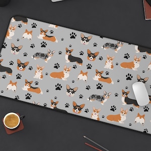May include: A gray and white mouse pad with a repeating pattern of cartoon corgis in various colors and poses. The corgis are surrounded by paw prints.