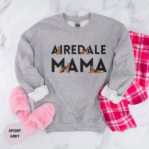 May include: A gray sweatshirt with the text "Airedale Mama" in black letters. There are small images of Airedale Terriers around the text.