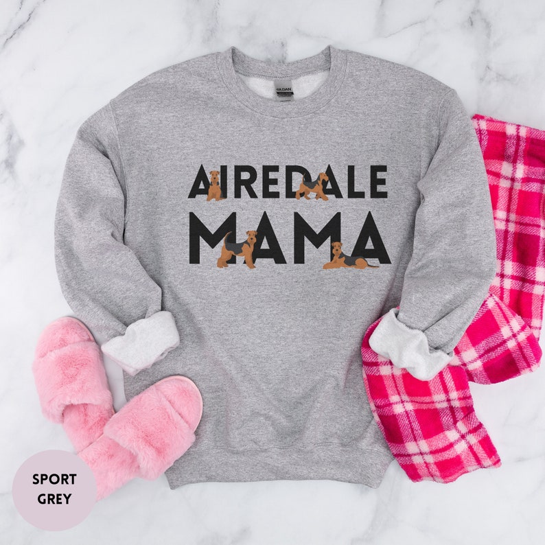 May include: A gray sweatshirt with the text "Airedale Mama" in black letters. There are small images of Airedale Terriers around the text.