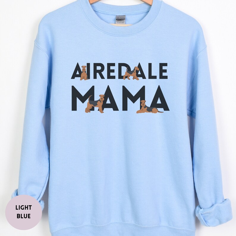 May include: A light blue sweatshirt with the text "Airedale Mama" in black letters. There are small images of Airedale Terriers around the text.