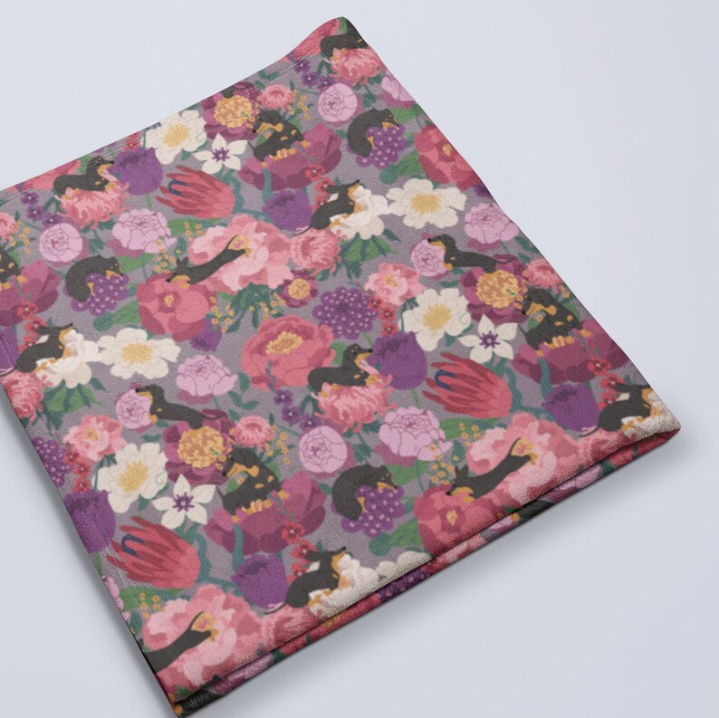 May include: A gray and purple fabric with a repeating pattern of black dachshund dogs and pink, white, and purple flowers.