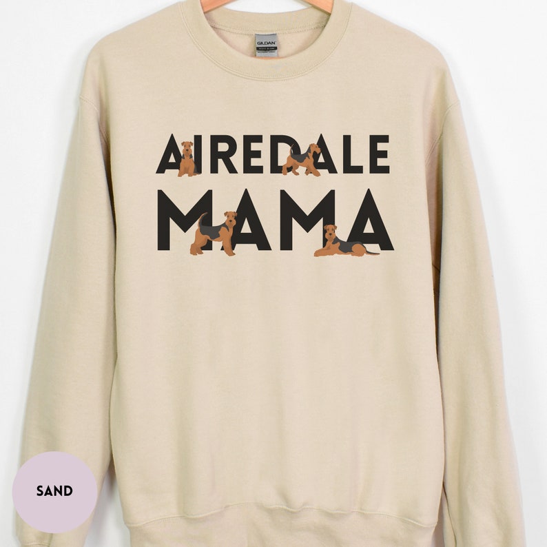 May include: A beige sweatshirt with the text "Airedale Mama" in black letters. The text is surrounded by small images of Airedale Terriers.