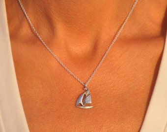 long necklace with steel chain and brass pendant in the shape of a sailboat handmade