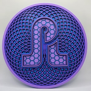 May include: A purple and blue 3D wall art piece with a geometric design. The design features a stylized letter "P" with a honeycomb pattern.