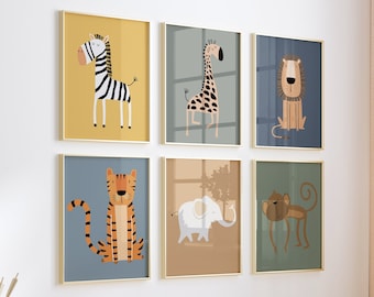 May include: Six framed illustrations of animals, including a zebra, giraffe, lion, tiger, elephant, and monkey. The frames are gold and the illustrations are in a cartoon style. The frames are hanging on a white wall.