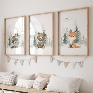 May include: A nursery room with a wooden bench and storage bins. The bench has three pillows and a stuffed giraffe. Three framed prints with watercolor illustrations of a raccoon, bear, and fox in a forest setting hang on the wall above the bench.