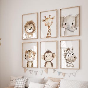 May include: Set of six watercolour animal prints featuring a lion, giraffe, elephant, tiger, monkey and zebra. Each print has a white background and is framed in a light wood frame.
