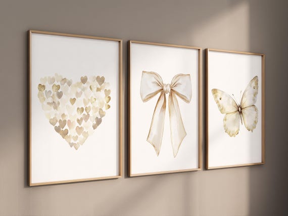 Beige gold wall art set with heart, bow, and butterfly prints. Neutral nursery, modern decor for bedroom, nursery, girls room, teen room