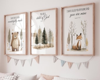May include: Three framed art prints with watercolour illustrations and inspirational quotes. The first features a bear, the second trees, and the third a fox. Each print has a wooden frame and is decorated with a banner of small flags.