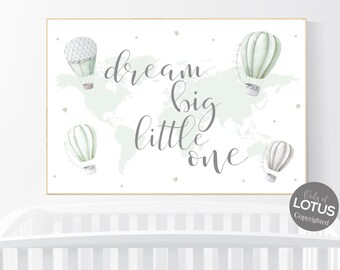 May include: A white nursery print with a green watercolor world map and the text "dream big little one". Four green and white hot air balloons are scattered around the map.