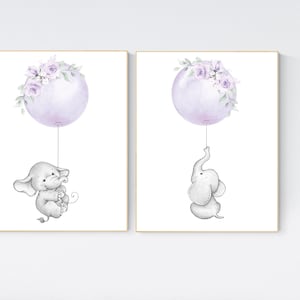 May include: Two printable nursery art prints featuring a cute gray elephant holding onto a purple balloon with lavender floral accents.