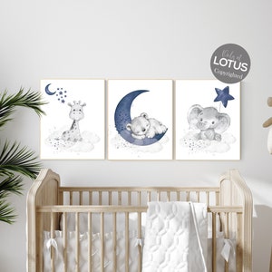 May include: A set of three nursery prints featuring a giraffe, a bear, and an elephant. Each animal is depicted in a watercolor style with a blue crescent moon and stars. The prints are perfect for a baby's room.