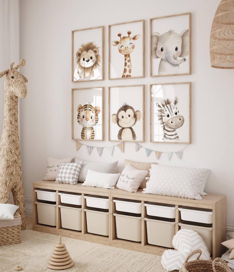 May include: A set of six framed animal prints featuring a lion, giraffe, elephant, tiger, monkey, and zebra. The prints are in a watercolour style and have a light brown background. The frames are a light wood colour.