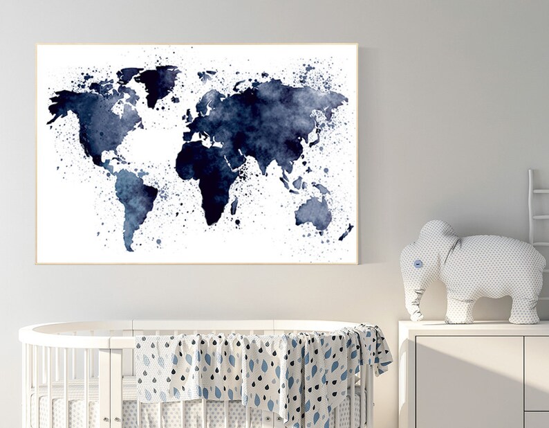 May include: A framed watercolor world map print in shades of navy blue. The map features a splattered paint effect, with continents and countries rendered in varying intensities of blue against a white background. The artwork is displayed in a light-colored frame.