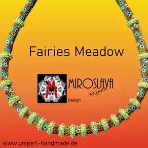 May include: A green, white, and multi-colored beaded necklace with a floral pattern. The necklace is in the shape of a circle and has a beaded design that resembles a flower. The necklace is labeled "Fairies Meadow" and "Miroslava Felguth Design".