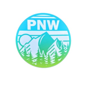 May include: A round sticker with a blue to green gradient. The sticker features a white mountain range with a sun and the text "PNW" in white.