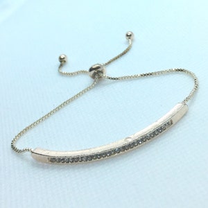 Hot New,Sliding Knot Golden Tennis Bracelet with Center Diamond Bezel