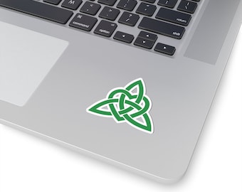 May include: A green Celtic knot sticker with a heart shape in the centre. The sticker is on a silver laptop.