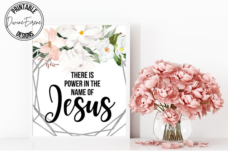 May include: A white printable art print with a floral design and the text "There is power in the name of Jesus".