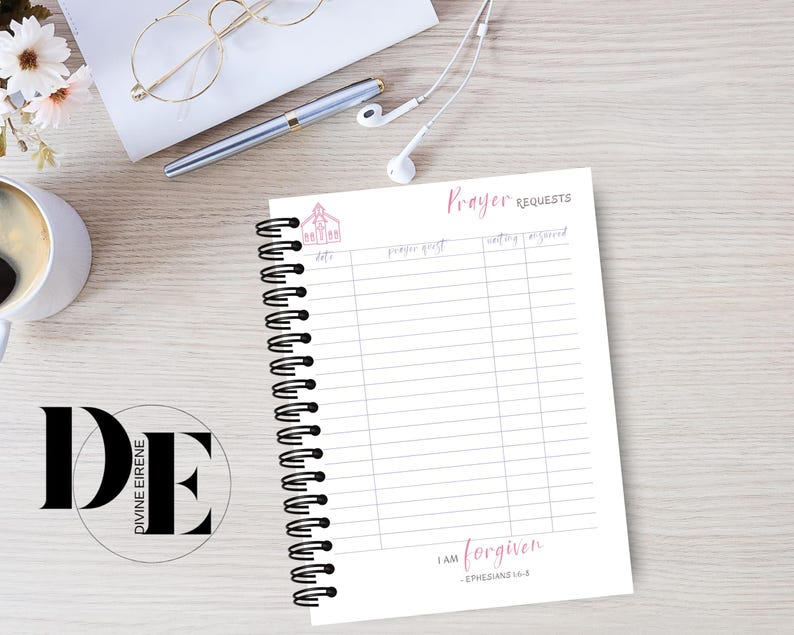 May include: A white prayer journal with a black spiral binding. The cover features a small pink church illustration and the text "Prayer Requests". The bottom of the journal has the text "I am forgiven - Ephesians 4:32".