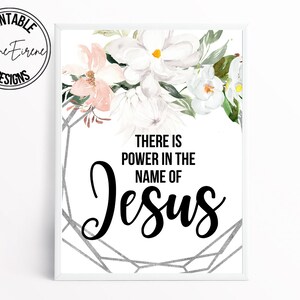 May include: A white printable art print with a floral design and the text "There is power in the name of Jesus".