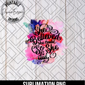 May include: A sublimation design featuring a watercolour background in shades of pink, purple, and blue. The text "She Believed She Could So She Did" is written in black cursive lettering.