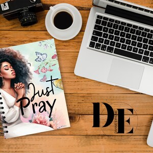 May include: A spiral bound journal with a colorful floral design and a woman with her eyes closed in prayer. The journal cover features the text "Just Pray".