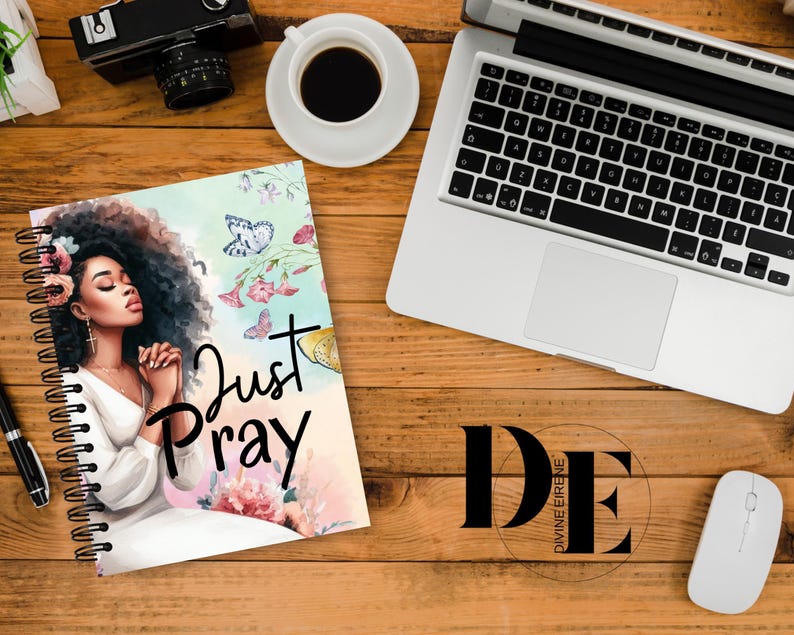 May include: A spiral bound journal with a colorful floral design and a woman with her eyes closed in prayer. The journal cover features the text "Just Pray".