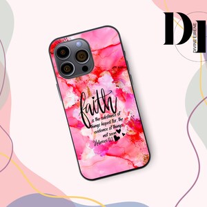 May include: A smartphone case with a vibrant pink and red abstract design. The case features the word "faith" in elegant script, along with a quote from Hebrews 11:1. The case has a glossy finish and a black camera module.
