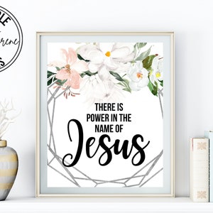 May include: Printable wall art with a floral design and the text "There is power in the name of Jesus".