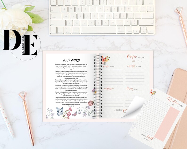 May include: A pink and white prayer journal with a floral design on the cover. The journal has a spiral binding and includes sections for prayer requests, praise, confession, and thanks. The journal also includes a reflection page with a floral design and the text "I am the light".