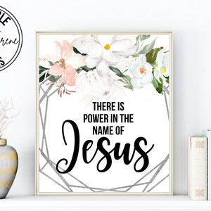 May include: Printable wall art with a floral design and the text "There is power in the name of Jesus".