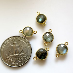 May include: Five gold-toned gemstone connector charms with a round, faceted labradorite stone. The charms have two jump rings for attaching to jewelry.