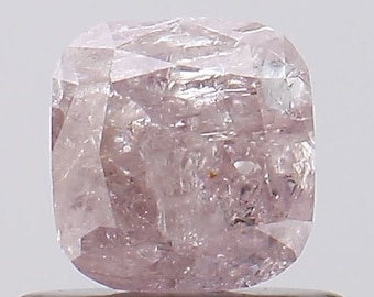 May include: A light pink, faceted, cushion-shaped diamond.