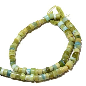 May include: A strand of green and blue opal beads. The beads are round and have a smooth, polished finish. The beads are strung on a thin, clear thread.